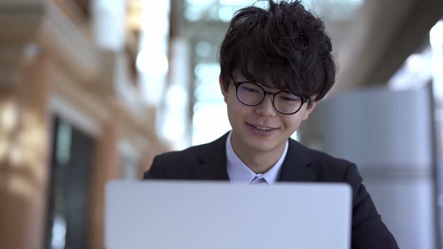 Asian man using laptop,