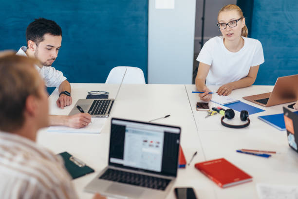 istock Staff communicate at work by sitting at desk 1353600898
