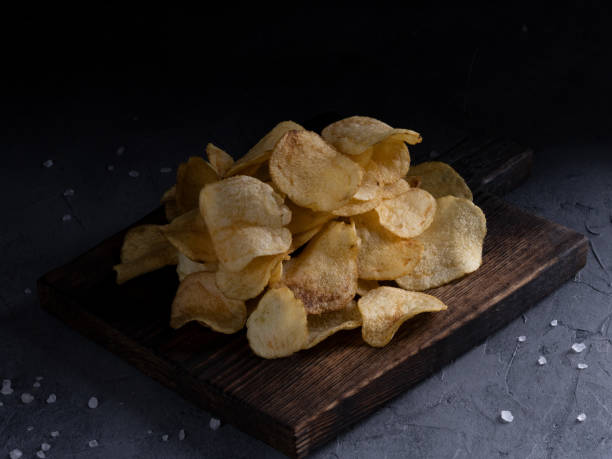 istock natural potato chips on a gray concrete background 1353604185