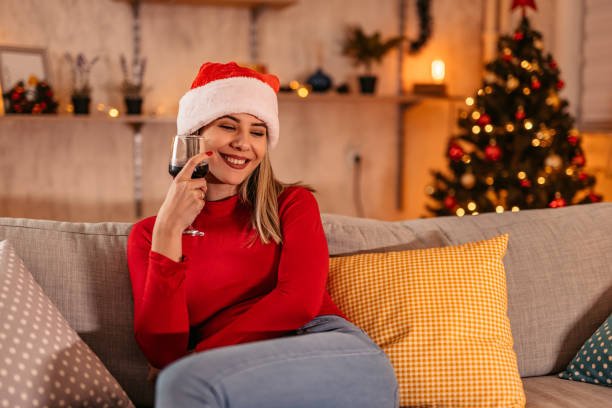 istock Woman relaxing during Christmas holidays drinking wine 1353604698