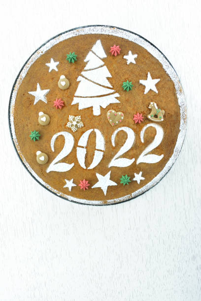 istock 2022  new years cake on white wooden table background 1353606545