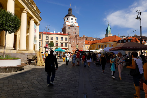 Lublin, Poland - September 10, 2021: The wide pedestrian route towards the famous Krakow-Gate leading to the old town. There are people visiting stalls set up in connection with the ongoing event. It is one of the countless great tourist destinations, being a significant tourist attraction, is often and numerously visited by many tourists from all over the world.