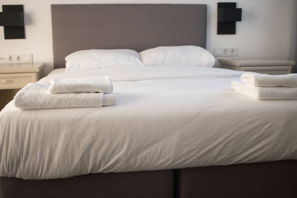 istock White clean towels stacked on the hotel bed 1353607318