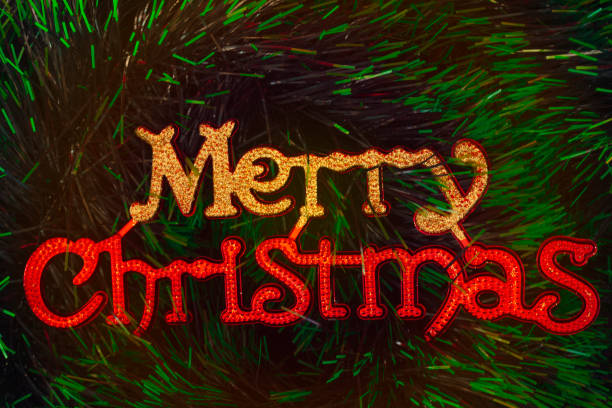 istock Christmas tree background with colorful Merry Christmas lettering for text 1353608797