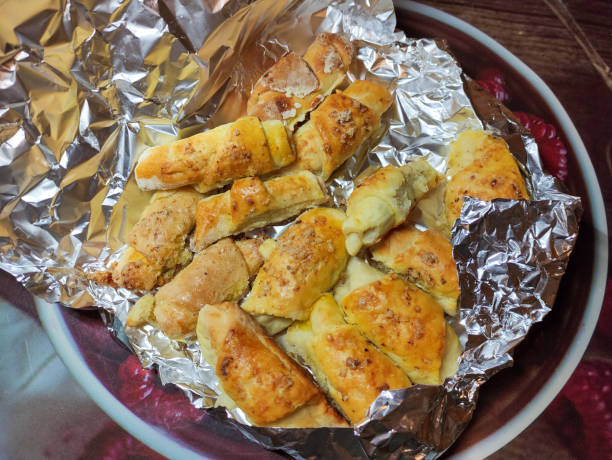istock Homemade rolled buns with walnuts wrapped in the foil 1353609210
