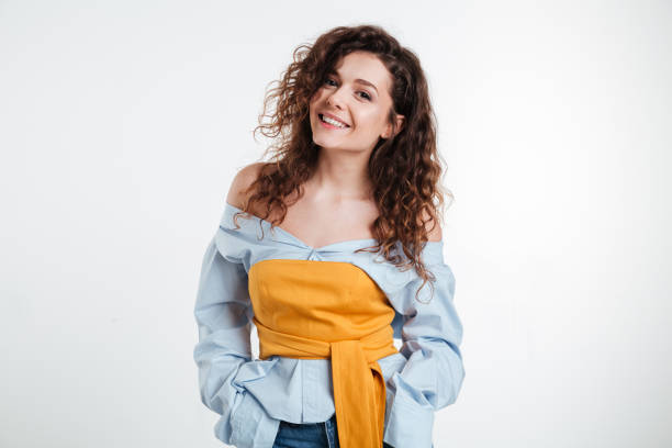 istock Beautiful young woman standing with hands in pockets 1353609468