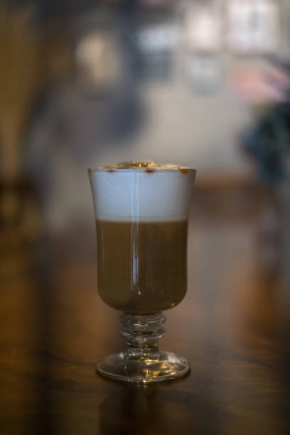 istock Glass cup with latte is on the table in coffee shop. 1353611452