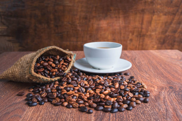 istock cup of coffee and coffee beans in a sack on Brown background 1353611700