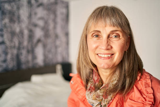 istock Mature woman smiling contently while relaxing at home 1353612824