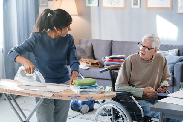 istock Volunteer helping to senior man with chores 1353613309