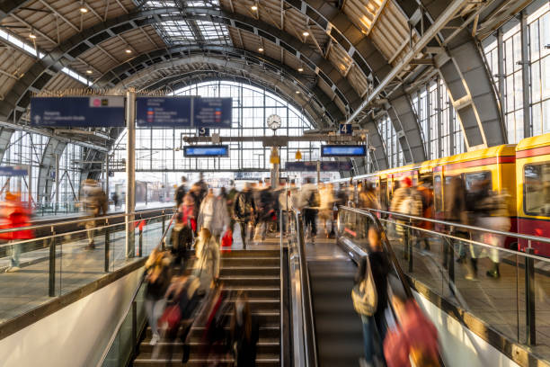 Busy train station platform with crowds of travelers and commuters.