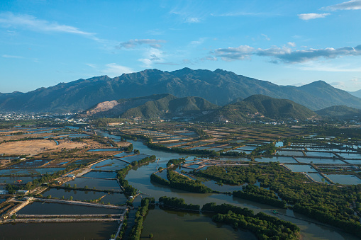 Drone view of the Chin Khuc mountains of Nha Trang city, by the Quan Tuong river, with mangrove forest and shrimp lake farm - Nha Trang city, Khanh Hoa province, central Vietnam