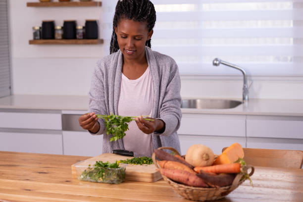 istock Woman preparing food in the kitchen. 1353615705