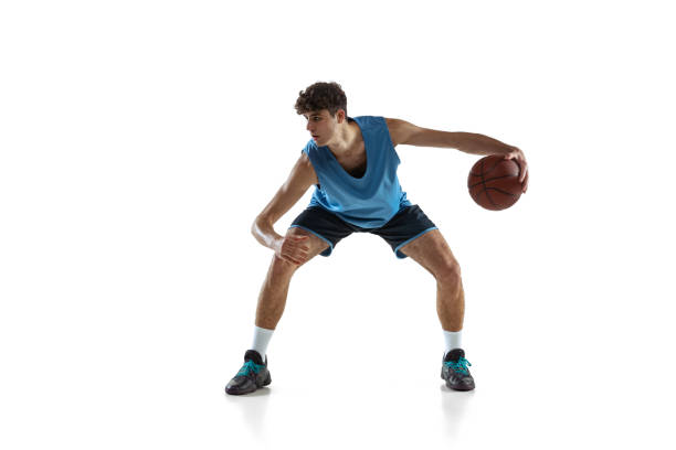istock Dynamic portrait of basketball player practicing isolated on white studio background. Sport, motion, activity, movement concepts. 1353616758