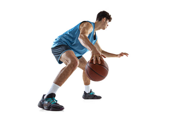 istock Full length portrait of basketball player practicing isolated on white studio background. Tall muscular athlete dribbling the ball. 1353616766
