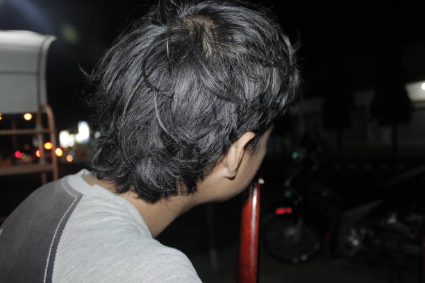 back view of a man's head as he looks ahead