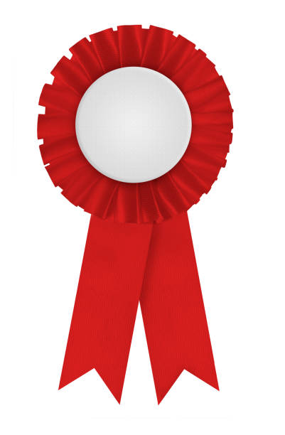 Circular pleated red ribbon winners rosette with blank white center for applying a design to. Photographed on a blank white background.