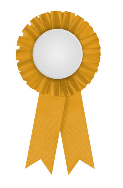 Circular pleated ribbon winners badge Golden rosette with blank white center for applying a design to. Photographed on a blank white background. Often associated with achievement and winning. An icon of equine pageantry for horses, political rank and contests in general. beauty queen stock pictures, royalty-free photos & images