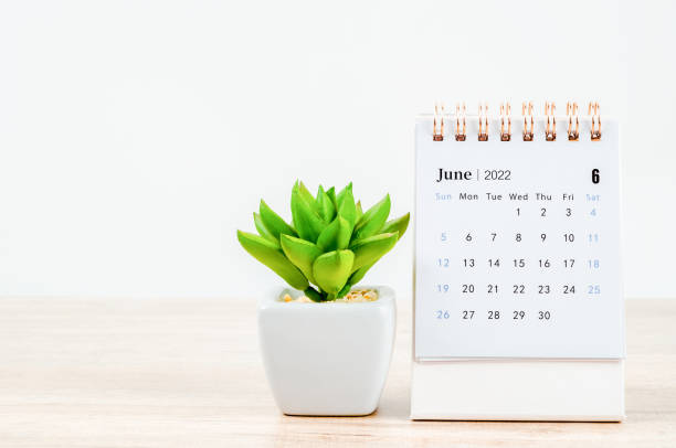 istock June 2022 desk calendar on wooden table. 1353619638