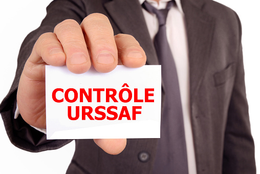 URSSAF control concept with an anonymous man showing a card