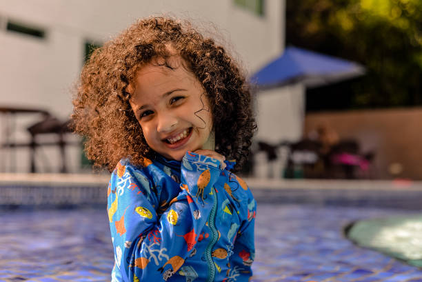 istock small girl smiling in the pool 1353619667