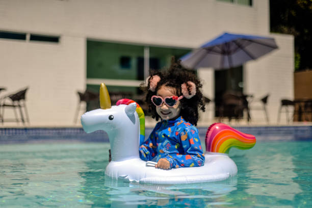 istock small girl smiling on lifebuoy. 1353619816
