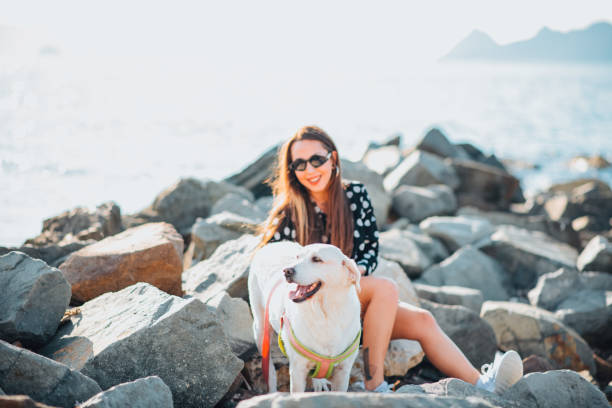 istock Young Woman on the Beach With Her Dog 1353621317