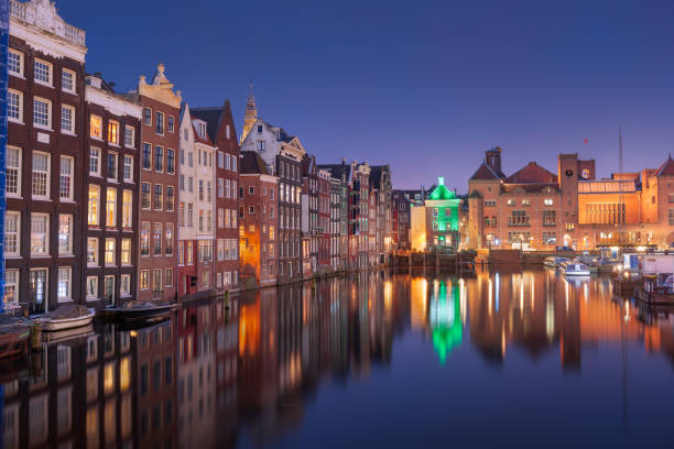 istock Amsterdam, Netherlands in Damrak at Night 1353622146