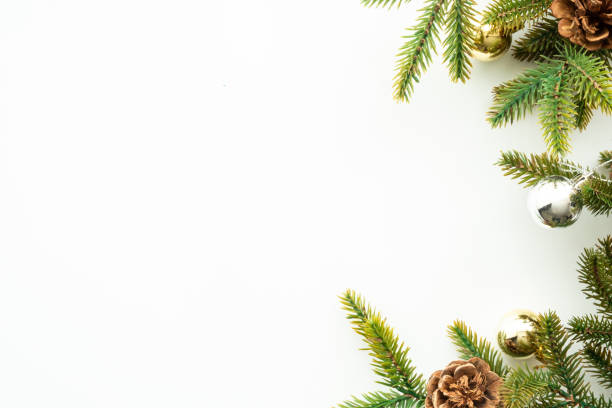 istock White table with Christmas decoration including pine branches and pine cones with golden balls. Merry Christmas and happy new year concept. Top view with copy space, flat lay. 1353622979