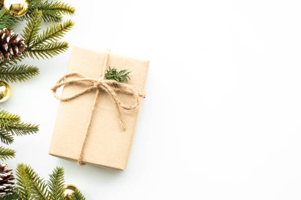 istock Beautiful Christmas background with gift box, decorate with pine branch and pine cone over white background. Top view with copy space, flay lay. 1353623190