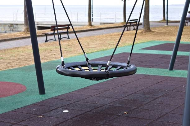 istock A swing on a children's playground in a public park (Umbria, Italy, Europe) 1353623460