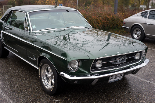 Mulhouse - France - 14 November 2021 - Front view of green Ford Mustang 1967 parked in the street