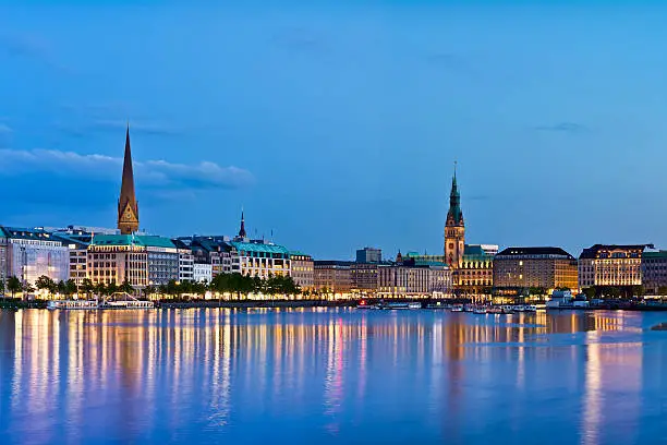 The Lake Binnenalster in Hamburg in Germany during the blue hour in the evening.