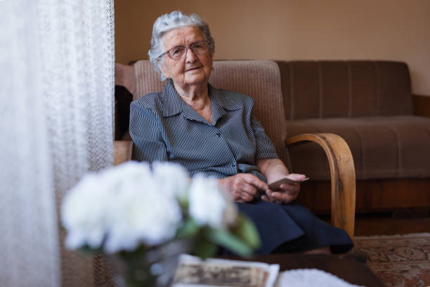 istock Grandmother with an old photograph 1353625209