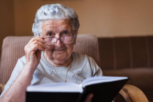 istock Senior woman reading a book 1353625234