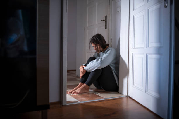 istock Woman Having A Mental Breakdown Sitting On The Floor 1353629786