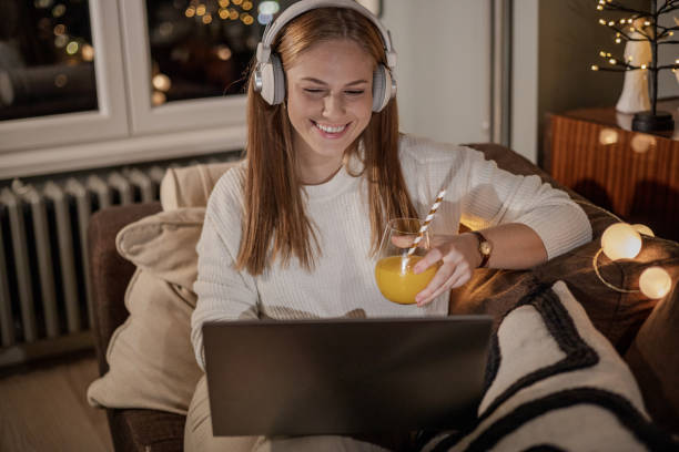 istock Consuming internet content in cozy living room during the evening 1353631069