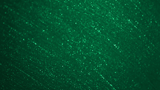 Christmas Green Glitter Background Abstract Bokeh Pattern Glittering Emerald Teal Dark Chiffon Textile Texture Fantasy St. Patrick's Day Shiny Dust Particle Circle Backdrop Macro Photography Soft Focus Design template for presentation, flyer, card, poster, brochure, banner