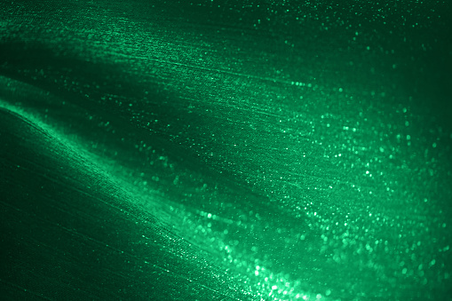 Christmas Green Glitter Background Abstract Emerald Dark Teal Wave Bokeh Lights Pattern Textile Tulle Netting Chiffon Glittering Fantasy Texture St. Patrick's Day Silk Particle Dust Circle Backdrop Shiny Macro Photography Design template for presentation, flyer, card, poster, brochure, banner