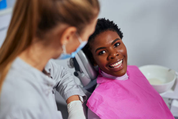 istock Smiling patient and dentist in office 1353632991