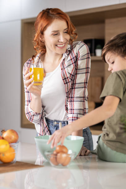 istock Mother and son baking cookies together at home 1353633252