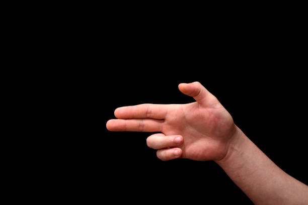 istock man's hand imitates a pistol on a black background 1353638144