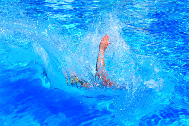 istock human hand over water.  drowning man 1353638660