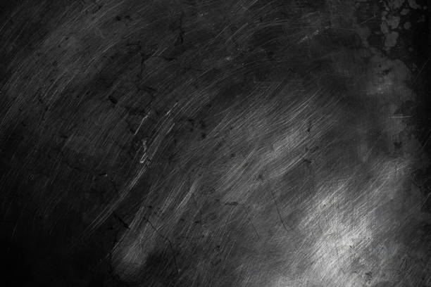 istock Black scratched metal texture in low light background 1353639613