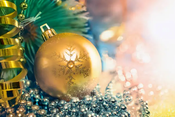 Christmas Golden ball with crystals   on the background of fir branches
