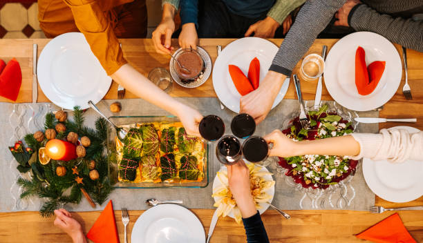 istock overhead table top shot of friends during christmas dinner 1353642910