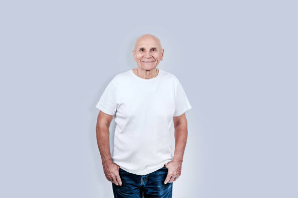 istock Senior man wearing white shirt with empty space for mockup 1353647013