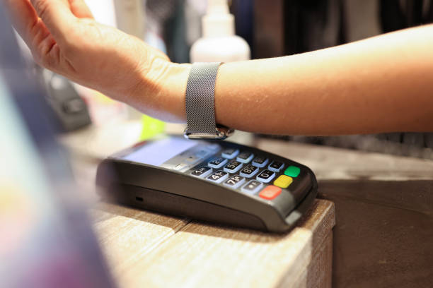 istock Man puts smart watch to payment terminal and makes payment 1353648805