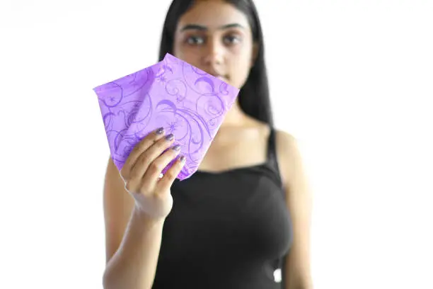 Young woman holding sanitary pads.