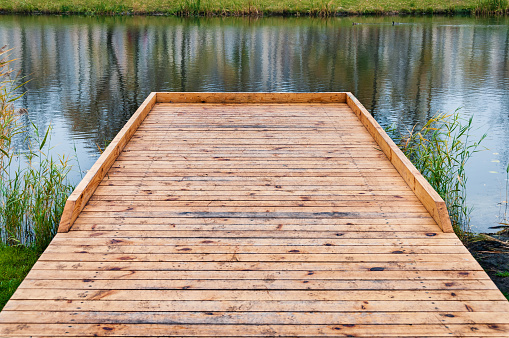 New wooden pier for fishing on the lake